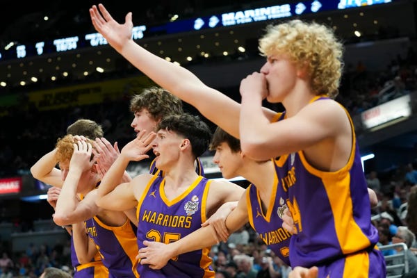 The Scottsburg Warriors bench players celebrate after a score against the South Bend St. Joseph Huskies on Saturday, March 30, 2024, during the IHSAA boys basketball Class 3A state championship game at Gainbridge Fieldhouse in Indianapolis. The Scottsburg Warriors defeated the South Bend St. Joseph Huskies 67-57. Joe Timmerman/IndyStar