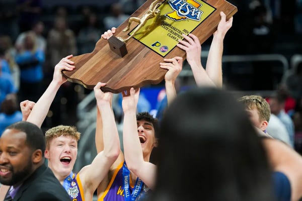Scottsburg Warriors players celebrate after winning state against the South Bend St. Joseph Huskies on Saturday, March 30, 2024, during the IHSAA boys basketball Class 3A state championship game at Gainbridge Fieldhouse in Indianapolis. The Scottsburg Warriors defeated the South Bend St. Joseph Huskies 67-57. Joe Timmerman/IndyStar